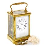 A brass cased carriage clock bearing Scouting crest, with white enamel dial and Roman numerals, the