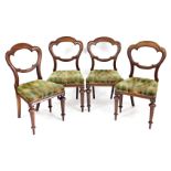 A set of four Victorian mahogany balloon back chairs, each with a lobed back, a padded seat on turne