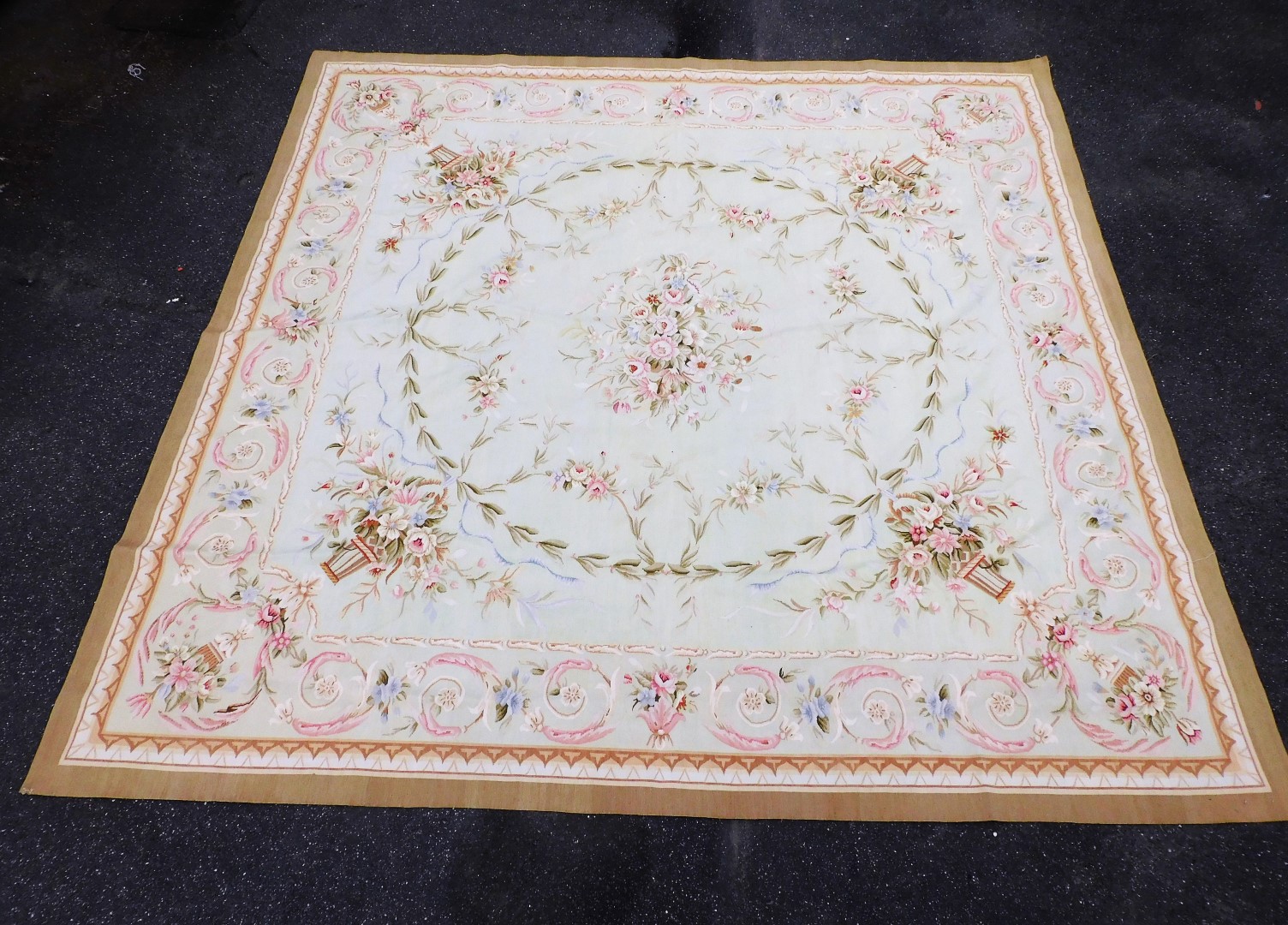 An Aubusson style tapestry hanging or rug, decorated with scrolls, urns, flowers, in pastel colours