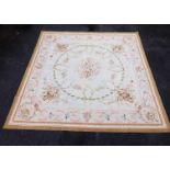 An Aubusson style tapestry hanging or rug, decorated with scrolls, urns, flowers, in pastel colours