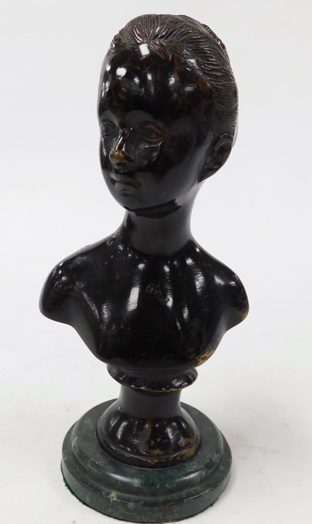 An early 20thC Continental bronze bust of a girl, raised on a green marble socle, 22cm high.