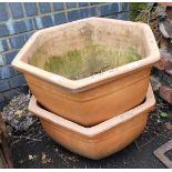 A pair of terracotta plant pots, of hexagonal tapering form, each 62cm wide. (AF)