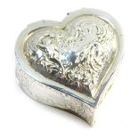 A Victorian silver heart shaped box, repousse decorated with buildings, shells, putti, and rococo sc