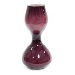 A late 20thC amethyst cased glass vase, of hour glass form, 40cm high.