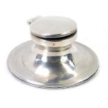 A George V silver capstan inkwell, with hinged lid, lacking interior, with a circular wooden base, B