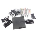 A PlayStation 2 games console, various controllers, and games.