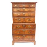 A George III figured walnut and cross banded tallboy or chest on chest, with moulded cornice and arr