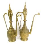 Two Eastern brass coffee pots, 70cm high.