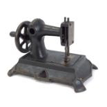 A 19thC child's cast iron sewing machine, possibly by Muller of Germany, unmarked, 16cm high, 23cm w