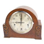 A 1950s Enfield oak cased mantel clock, with a silvered numeric dial, eight day movement with Westmi