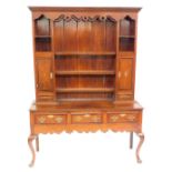 An early 19thC mahogany cross banded oak dresser, with shaped and moulded top to the plate rack, thr