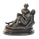 A resin bronze effect figurine of a male and female recumbent lovers, on an oval base, 25cm high, 26