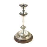 A 19thC Elkington and Co silver plated candle stand, on a turned wooden base, 27cm high.