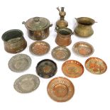 A group of Eastern copper and brass wares, comprising two pots, each with swing handle, cauldron wit