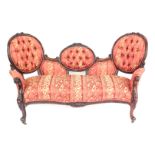 A Victorian mahogany show frame sofa, with triple cameo back and serpentine seat, with damask uphols