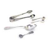 Two small silver pattern caddy spoons, a Continental white metal rose capped caddy spoon stamped 835