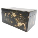 An early 20thC Japanese black lacquered cigarette box, painted with dragons, with steel lock plate,
