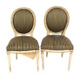 A pair of Louis XVI style salon chairs, with oval cameo backs and striped upholstery.