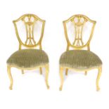 A pair of late 19thC Hepplewhite style Neoclassical giltwood salon chairs, with serpentine seats, 56