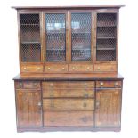 A Regency mahogany secretaire cabinet bookcase, with rosewood cross banding and ebony inlay, the