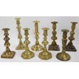 A selection of brass candlesticks, mainly singles but one pair. (a quantity)