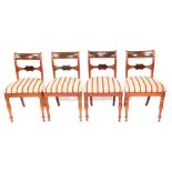 A set of four William IV mahogany dining chairs, with bar backs, Regency stripe seats, and turned le