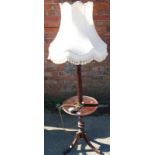 A mahogany standard lamp, with wine table base and shade.