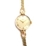 A 9ct gold Omega wristwatch, with 1cm diameter dial, with baton and Arabic numerals, marked Omega, w