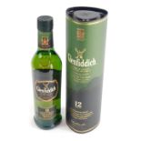 A bottle of Glenfiddich twelve year old signature malt, in cardboard tube.