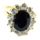 A 9ct gold cluster ring, set with central dark blue paste stone, surrounded by cz, in a raised baske