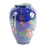 A 20thC pottery Adderley Limited Hollyhock pattern vase, typically decorated with flowers on an opal