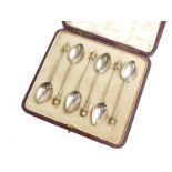A set of six George V silver coffee spoons, in case marked Mappin and Webb, with thistle tops, plain