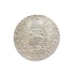 A silver coloured 8 Reales, with inscription BNUNM 1743 Philip.