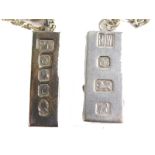 An Elizabeth II silver ingot, on slender link chain, Sheffield 1977, ingot ½oz, and a further ingot,