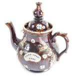 A Bargeware treacle glazed pottery teapot, with teapot knop, raised rosette and bird pattern, marked