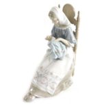 A large Lladro figure, lady sewing, printed marks beneath, 31cm high.