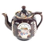 A Bargeware treacle glazed pottery teapot and cover, the body raised with rosettes and flowers, mark