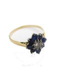 A sapphire and diamond floral cluster ring, with central old cut diamond approx 0.12cts, surrounded