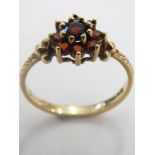 A 9ct gold garnet cluster ring, the flower head set with round brilliant cut garnets, with leaf mark