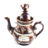 A Bargeware treacle glazed teapot, the domed lid with teapot knop, the main body raised with birds a