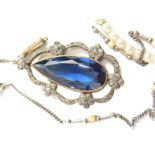 A 20thC pendant, with teardrop blue coloured stones, surrounded by a small floral arrangement of whi
