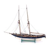 A 20thC wooden model of a warship, with realistic decking and masts on a green painted base, 64cm hi