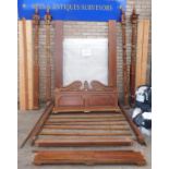 An Eastern hardwood and parcel gilt four poster bed, with moulded cornice, the posts carved and spir