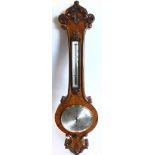 Pastorelli and Co of London. A Victorian walnut wheel barometer, the case carved with scrolls, leave