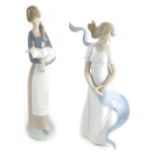 Two various Lladro figures, girl holding lamb, 29cm high, and a Nao figure La Caricia Del Viento of
