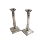 A pair of George V silver Corinthian column candlesticks, by Fentor Russel and Co Limited, on square