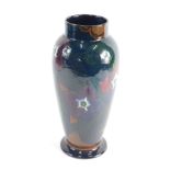 A 20thC Decoro pottery vase, decorated with flowers on a subdued green and brown ground, printed mar