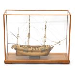 A 20thC 1:64 scale model of a warship, by G. T. Smart, with realistic decking and masts, in a glazed