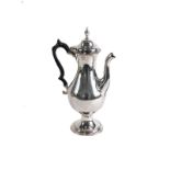 A George III plain silver coffee pot, by Hester Bateman, with urn finial, domed lid, ebonised thumb