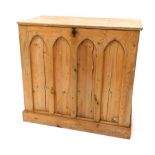 An early 20thC pine side cabinet, with mitre shaped panels, on a block base, 82cm high, 89cm wide, 4